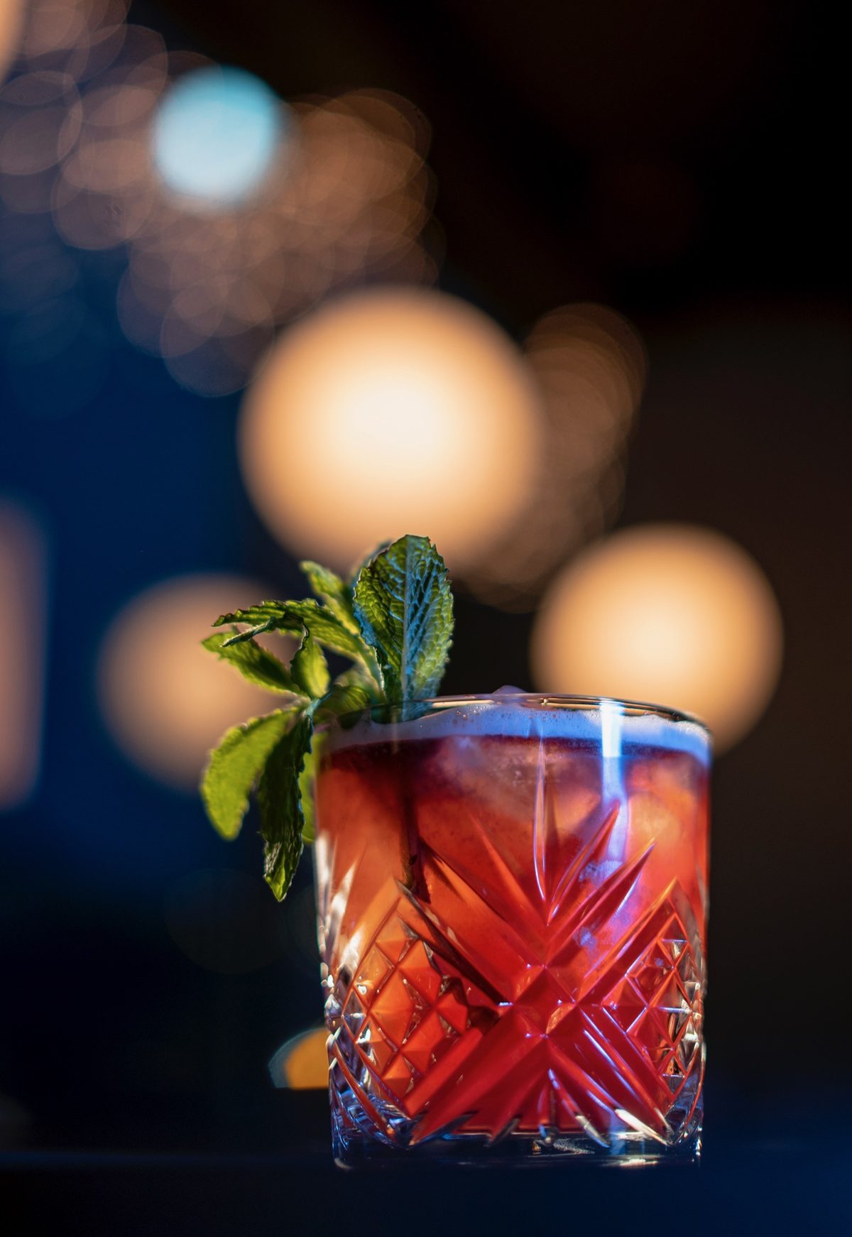 A cocktail garnished with fresh mint