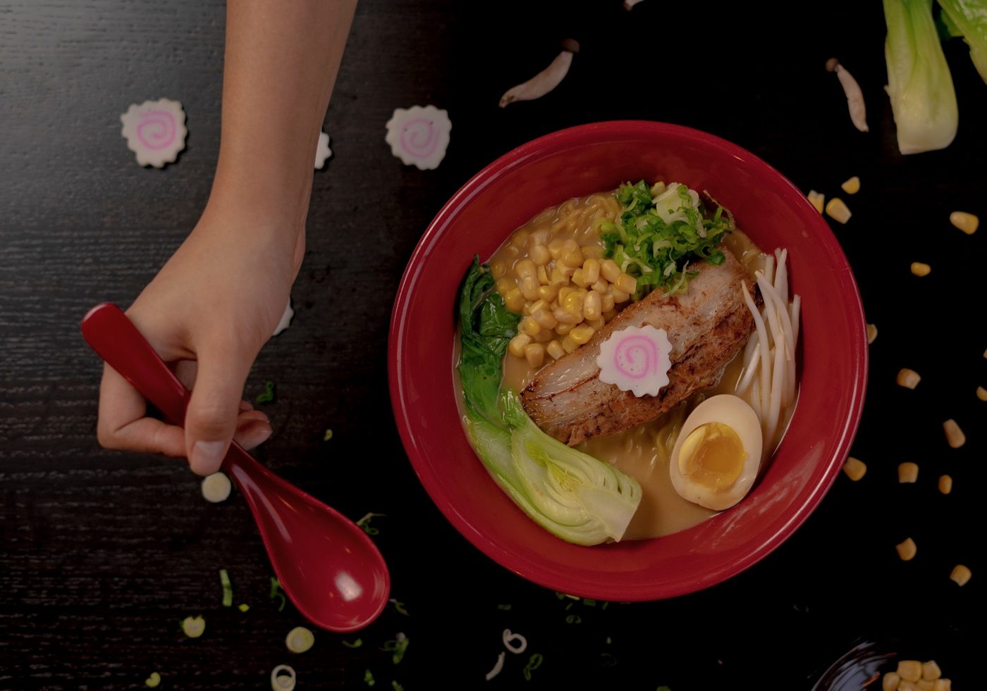 A bowl of ramen in a red bowl